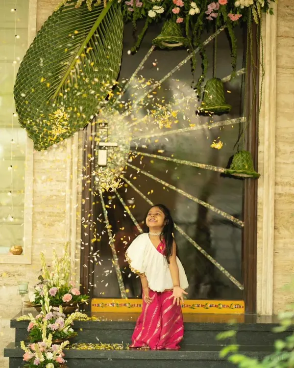 This little girl is having the time of her life in our classic White Rani Jumpsuit. The leheriya print pants and one-shoulder drape make it a stylish yet incredibly comfortable choice for any event.