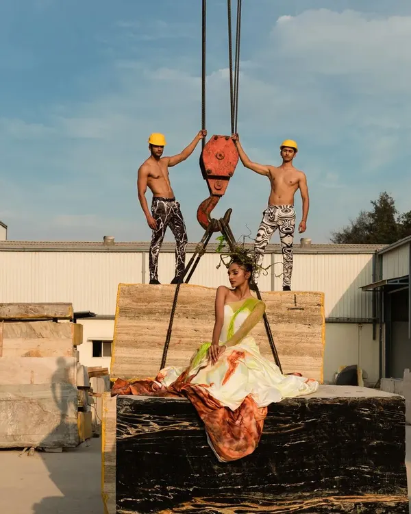 For this conceptual shoot with Pearl Marble Inc, we used the raw, industrial setting of a marble factory to create a high-fashion narrative. The contrast between the elegant gown and the heavy machinery, like this crane, produces a powerful and memorable image.