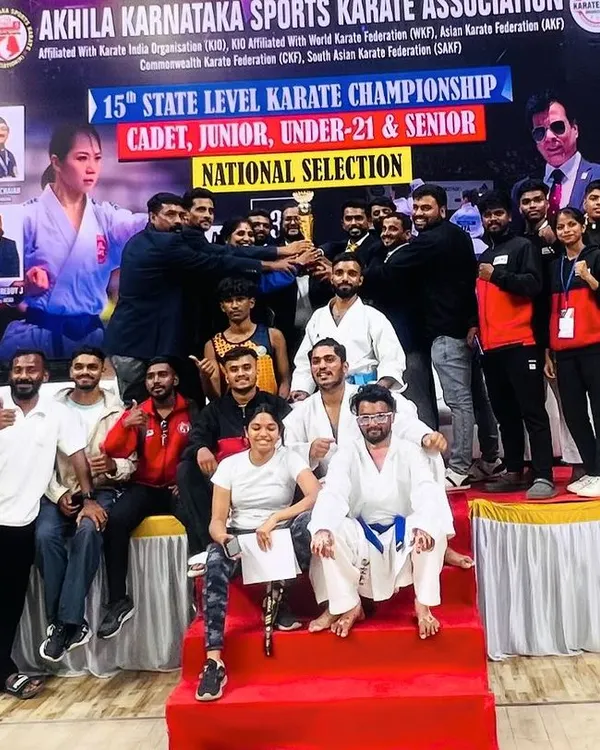 Team UMC celebrating a major victory at the 15th AKSKA State Karate Championship. Holding the team trophy high, this picture captures the spirit of collaboration and the joy of shared success.