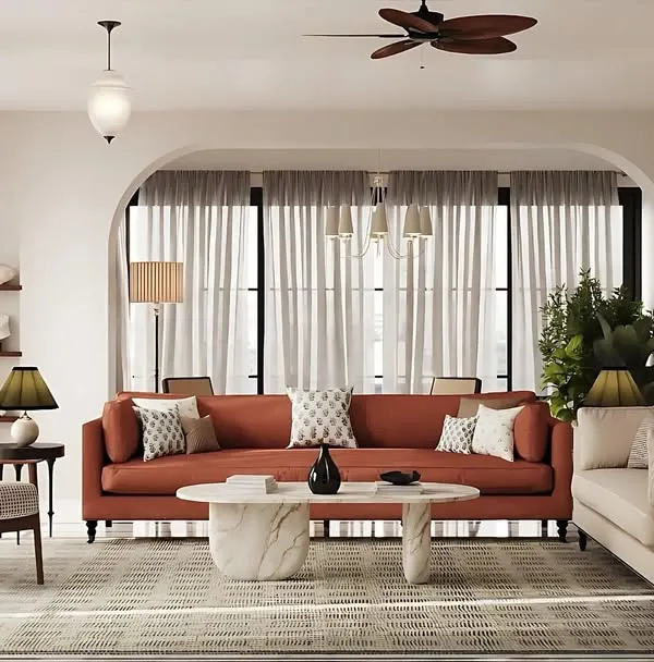 This living space from a bungalow renovation captures my love for creating serene, light-filled interiors. The design uses architectural arches and a soft, neutral palette to create a sense of calm grandeur, while the terracotta sofa adds a touch of warmth, reflecting a blend of European minimalism and Indian comfort.