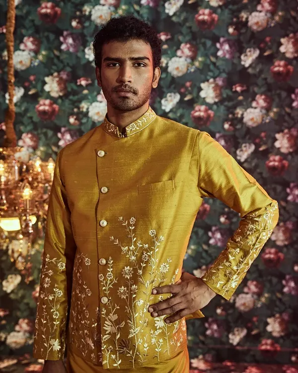 Our ethnic Haldi outfits are crafted from fine silk and feature exquisite hand embroideries, like the delicate floral patterns on this jacket.