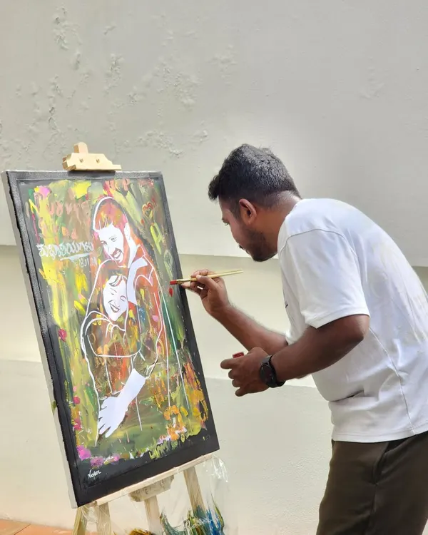 This is a close-up of me at work, focused on adding the fine details to a portrait. Each line is placed with intention to capture the likeness and emotion of the couple.