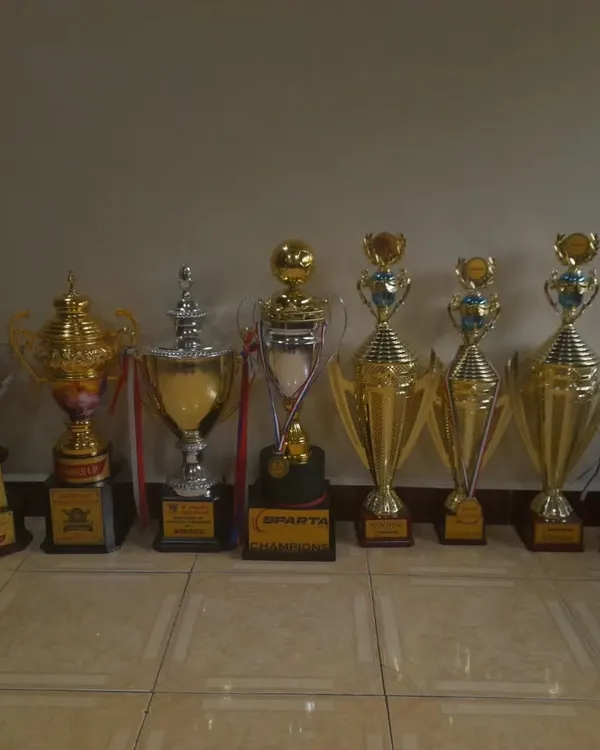 This is what success looks like. A lineup of the many trophies our teams have won, showcasing a legacy of victory across different age groups and tournaments.