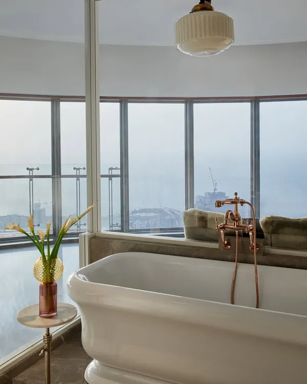 The pièce de résistance in this young lady's bedroom is the freestanding British tub overlooking the Mumbai cityscape. It adds a touch of unexpected luxury, transforming the room into a sophisticated and indulgent personal suite.