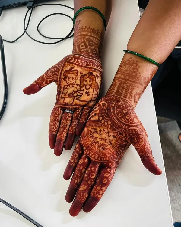 The beautiful, rich stain of a personalized Rakhi mehndi. This design features a cartoon of a brother and sister, along with a loving message, creating a cherished memory.
