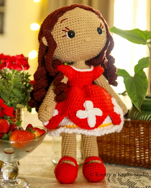 Meet Lily, my signature handmade crochet doll. She stands 19 inches tall with bouncy brown curls and a removable red dress, and her neutral expression is designed to be a quiet companion for a child's every mood, from happy to thoughtful.
