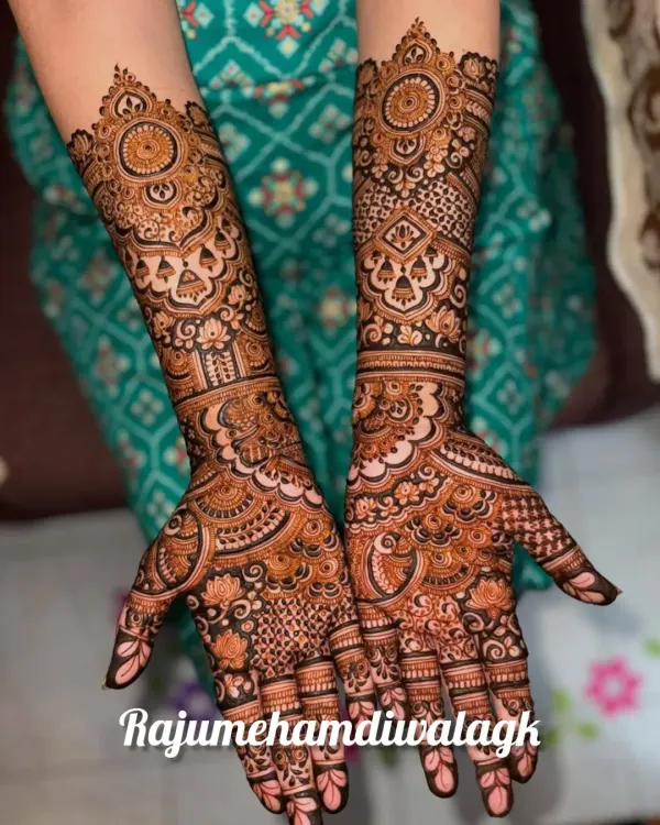 This is a classic full-coverage bridal design. We've used a mix of fine lines, bold floral mandalas, and traditional jaali (net) patterns to create a rich and textured look that extends up the forearm.