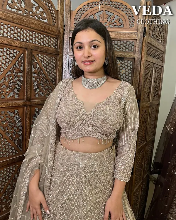 A close-up of this stunning beige lehenga. The intricate sequin work and modern blouse design make it a showstopper.
