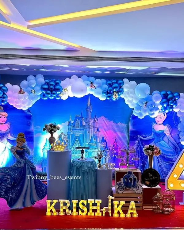 A magical Cinderella theme for Krishaka's 4th birthday. We created a stunning blue castle backdrop, complete with princess cutouts, a carriage-style cart, and marquee letters for a truly royal celebration.