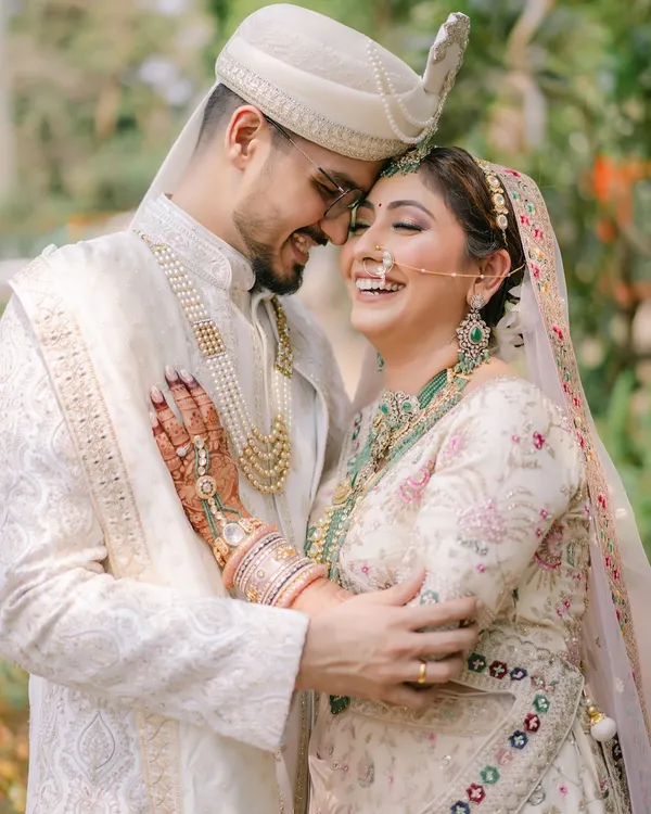 That laugh says it all! A candid moment of pure joy between the bride and groom. Her makeup is soft and natural, designed to last through all the happy tears and laughter of the day.