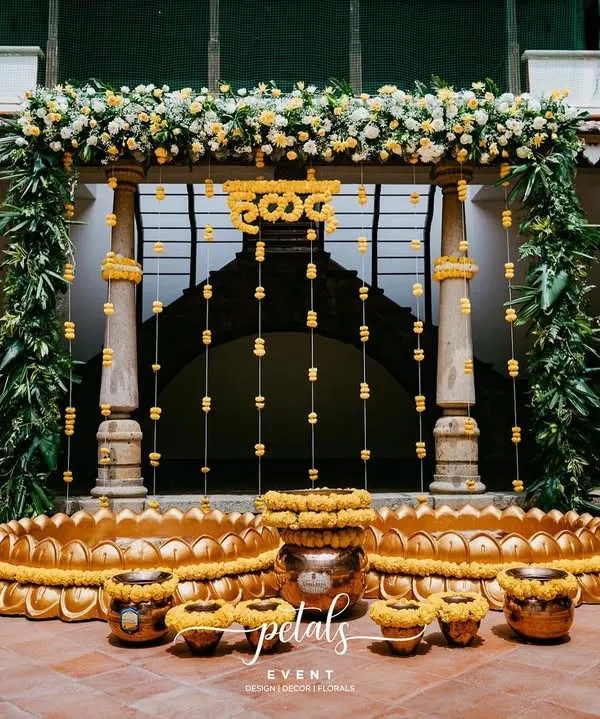 This Haldi decor at the heritage venue Angana the Courtyard is a true visual feast. I used vibrant marigolds, lush tropical leaves, and traditional brass urlis and pots to create a setting rich in cultural elegance.