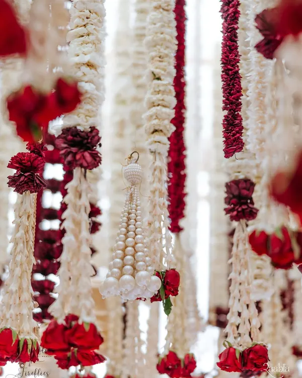 A close-up of the fragrant floral strings, or 'ladis', from the 'Laal Ishq' wedding. We used thousands of rajnigandha, mogra, and roses, a detail that speaks to the heart of traditional Indian wedding decor and craftsmanship.