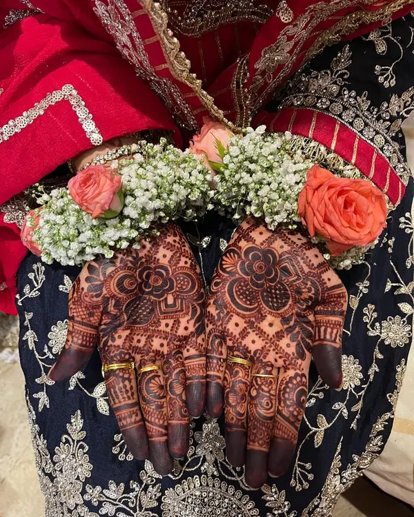 The beautiful, dark stain of a bridal henna, perfectly complemented by the bride's floral hand jewelry. This is the result of natural henna and proper aftercare.