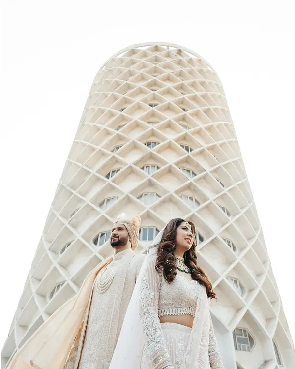 Your love story is a masterpiece, and it deserves a frame that is just as epic. I love finding unique perspectives, like using the stunning architecture of the venue to create a modern, powerful portrait that feels both grand and intimate.