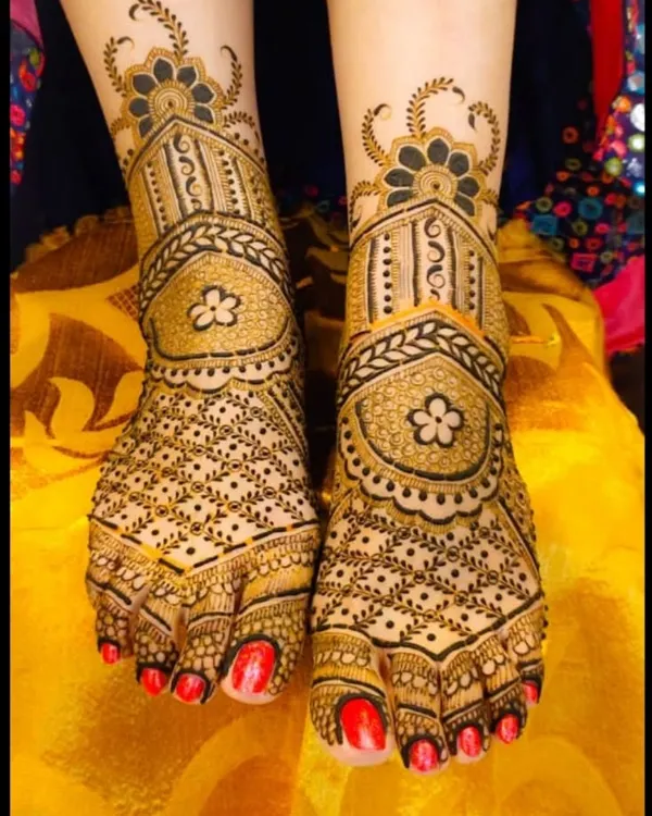 A classic foot mehndi design with symmetrical patterns, featuring delicate floral motifs and fine dot work for a clean and elegant look.