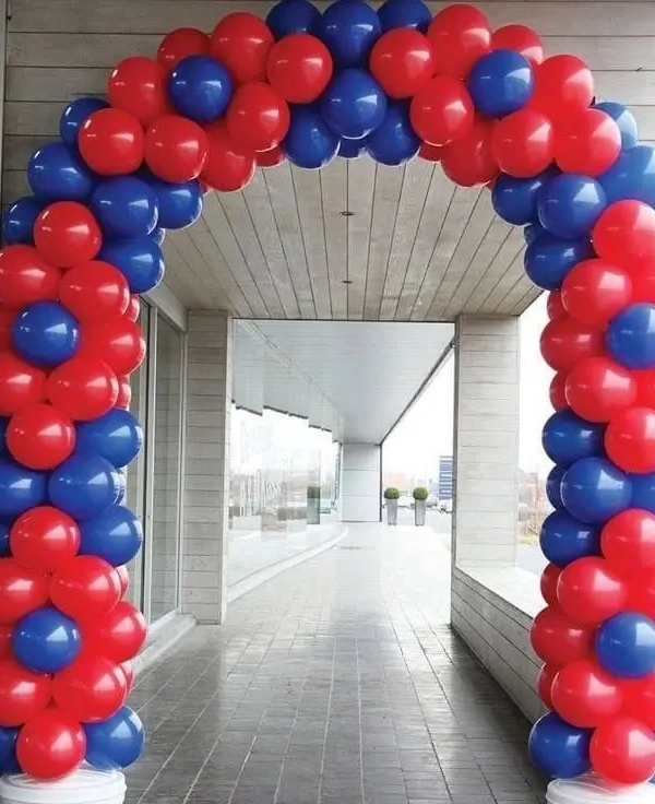 A classic spiral balloon arch in red and blue. This type of arch is perfect for marking the entrance to a party or corporate event.