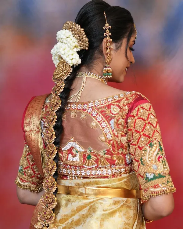 A beautiful back view of a bride's hairstyle, adorned with a traditional temple-style jade bille. This is a must-have hair accessory for a classic South Indian bridal look.