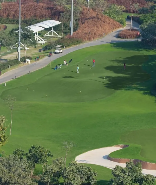 An Aerial View of the DLF Golf Academy: Our world-class facilities provide the perfect environment to elevate your game. This view showcases our expansive driving range and practice greens, designed for every skill level.