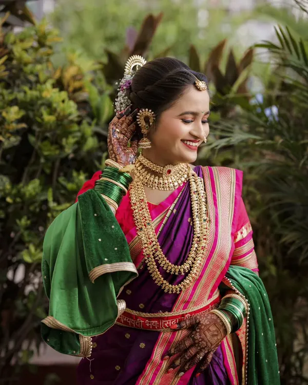 The pure joy of a bride on her wedding day, dressed in a stunning purple and green paithani. I focus on capturing these natural, happy expressions that truly reflect the moment.