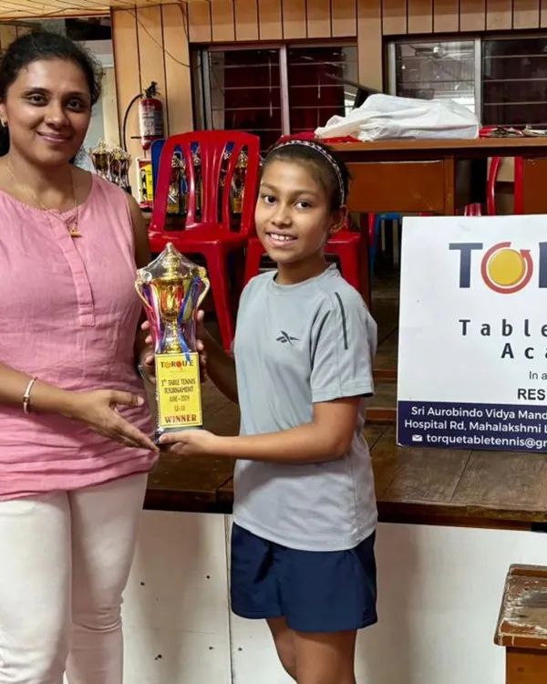 Anaya, at just 9 years old, holding her first-place trophy after winning the U11 Girls Tournament at the Torque Table Tennis league.