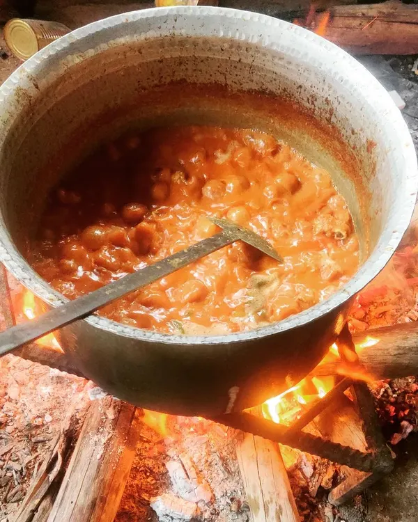 Our signature Mutton Dum Biryani being slow-cooked over a traditional firewood flame. This method infuses the rice and meat with a unique smoky aroma that you just can't get from a modern kitchen. It’s a taste of authentic celebration food.