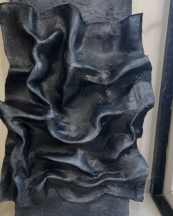 This 3D sculptural piece, with its deep, flowing folds, took almost five months to perfect. It was created for a special client in Kanpur and shows how texture can create a powerful, dramatic statement.
