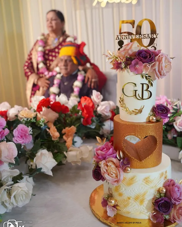 A cake as timeless as their love. This three-tier white and gold cake, adorned with delicate flowers, was for my parents' 50th anniversary. Every detail was a tribute to their beautiful journey together.