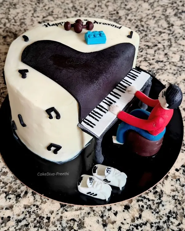 A special cake for a piano lover. This design features a hand-sculpted figure playing a grand piano, surrounded by personal touches like fondant dumbbells and Adidas shoes.