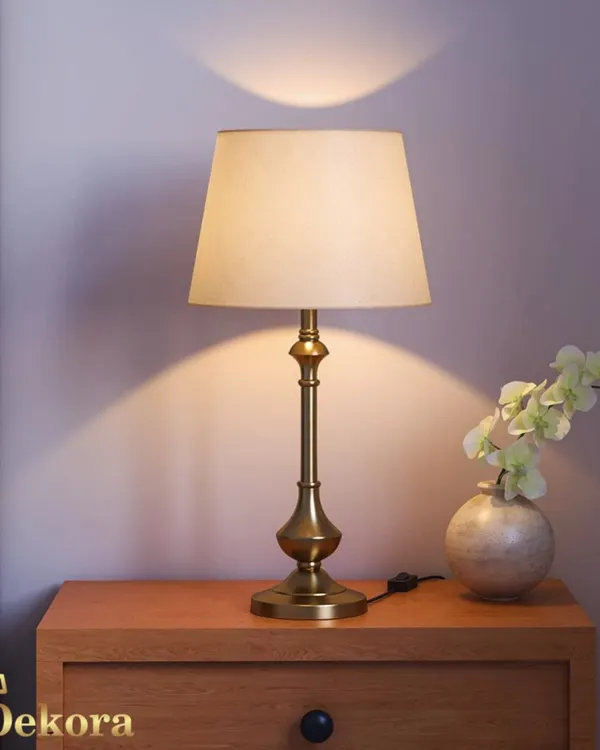 Our classic brass table lamp offers timeless elegance for any surface. The beautifully turned base and simple fabric shade create a warm, welcoming light, ideal for a traditional bedroom or a sophisticated study.