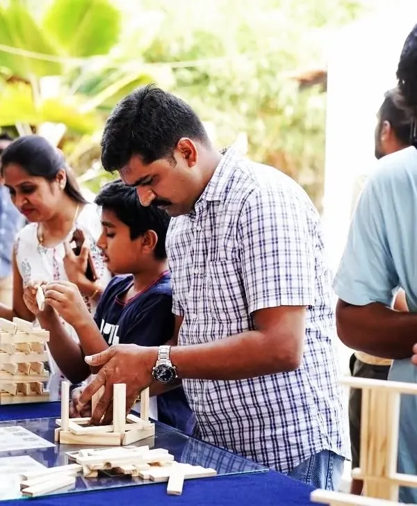 We believe the best moments are the ones shared. Here, a father and son are completely absorbed in their project, working together to bring an idea to life. Our workshops are designed to create these pockets of focused, screen-free time for families to connect and build memories, one block at a time.