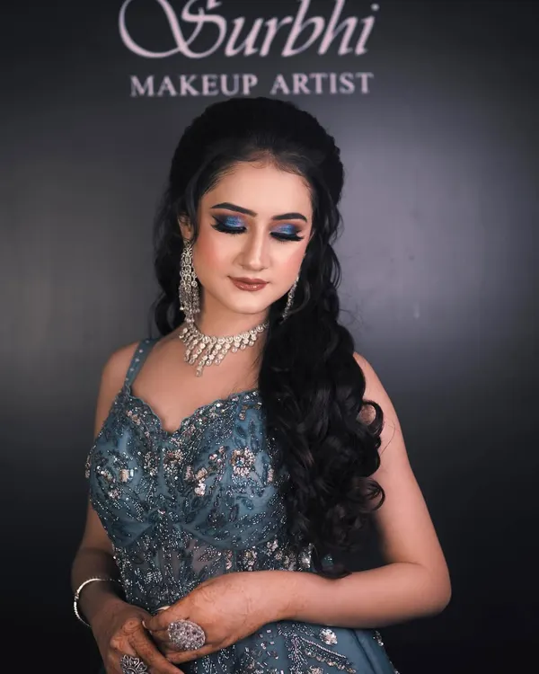 This engagement look is all about drama and elegance. I created a bold blue smokey eye to match her gown, paired with a flawless base and a soft nude lip to balance the look.