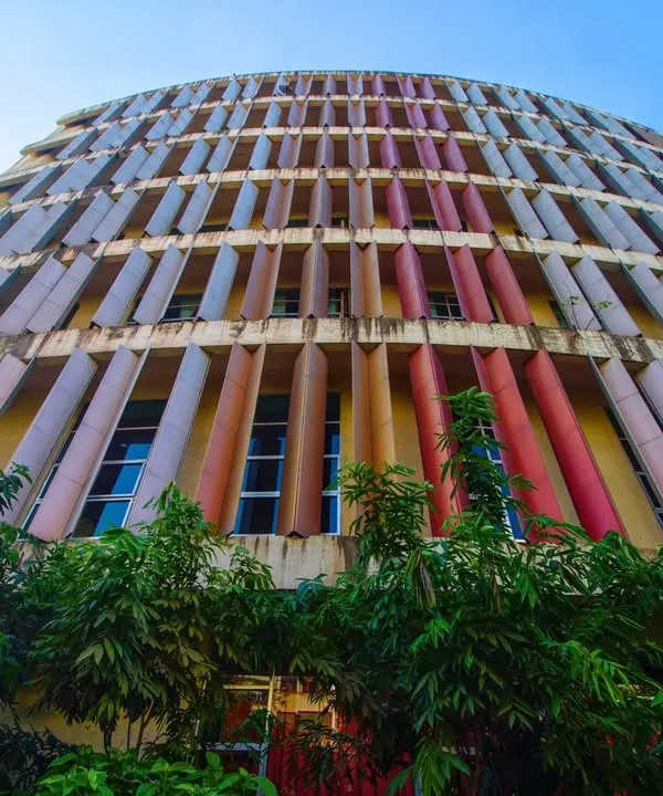 This low-angle view captures the dynamic, curved facade of the K.J. Somaiya College in Mumbai. We designed the multi-colored vertical fins not not only as a striking visual element but also as a functional system to modulate sunlight, ensuring the interior learning spaces are bright and comfortable throughout the day.
