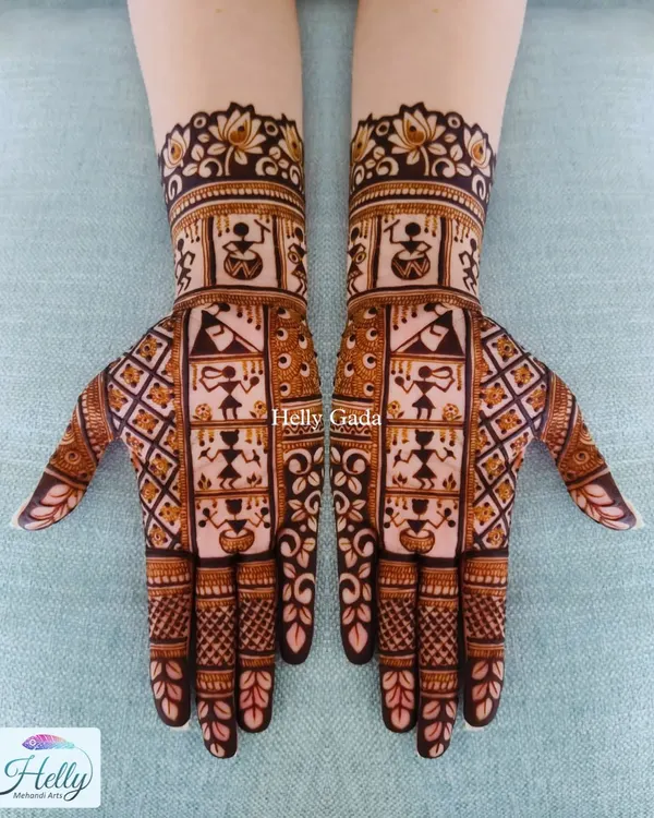 I love incorporating different art forms into my mehndi. This design features traditional Warli art, with its characteristic stick figures depicting scenes of village life, set within a geometric layout.
