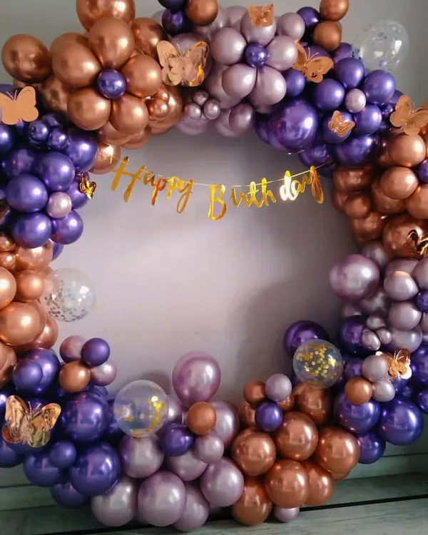 A full and dense circular balloon wreath made of purple and rose gold chrome balloons, perfect as a standalone photo backdrop.