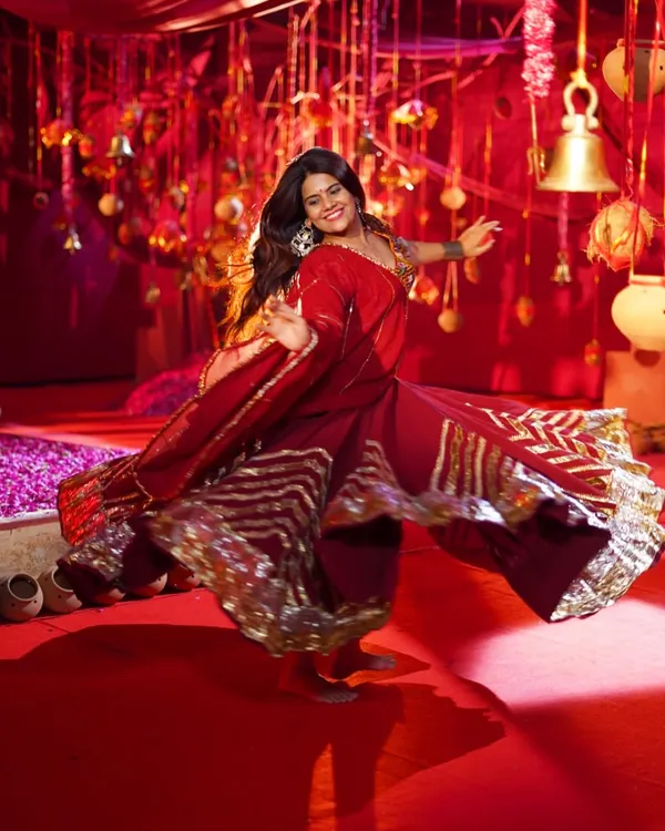 The perfect twirl in a stunning red traditional outfit. This ghagra choli is perfect for a vibrant Garba night or a grand sangeet performance.