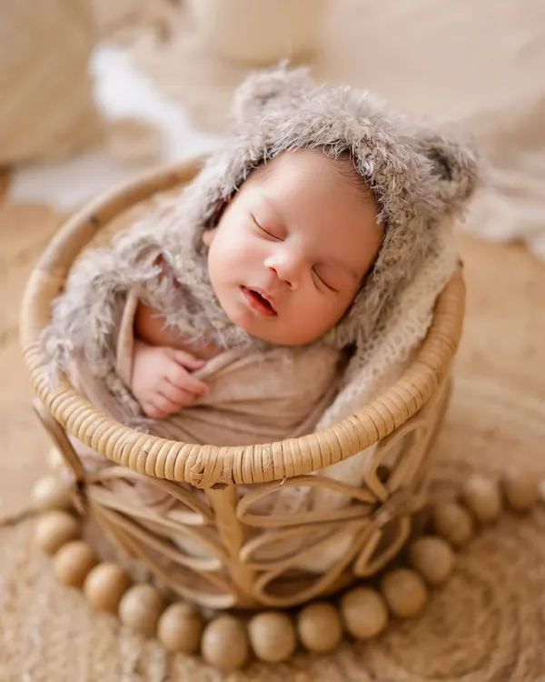 A perfect, sleepy portrait of a newborn in a fuzzy bear hat. My studio is full of unique, soft props to keep your baby comfortable and create adorable images.