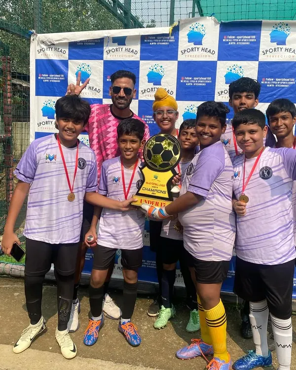 Pure joy and teamwork. Our U15 squad celebrates their championship win at the Sportyhead Premier League in Malad, holding the trophy high.