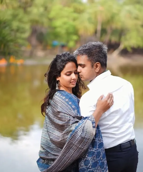 A romantic moment from our pre-wedding shoot. I chose a beautiful printed shawl to add a touch of traditional elegance to my simple blue and white outfit, coordinating perfectly with my husband's classic white shirt.
