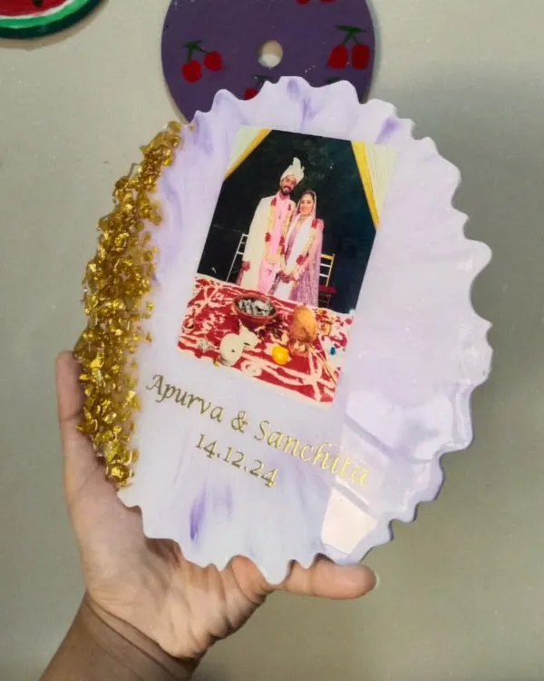 A custom resin couple frame made for Apurva and Sanchita. This piece features their wedding photo, names, and special date, set in a beautiful lilac resin with a gold rock edge.