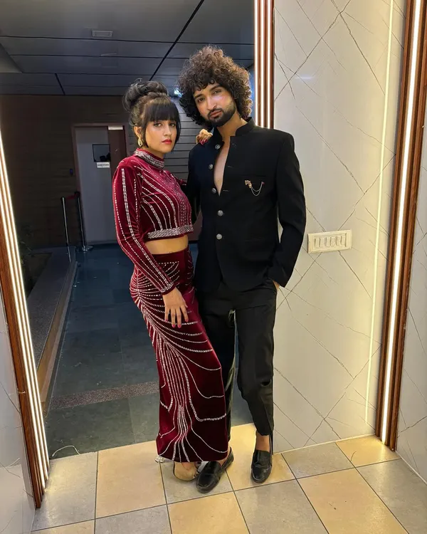 A behind the scenes photo from a perfume branding shoot, featuring models Manisha and Jeet in their coordinating styled looks.