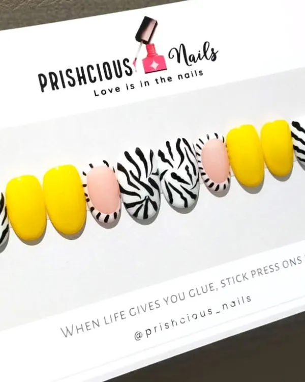 A bold and fun set of custom press-on nails. This design features a mix of bright yellow and a trendy zebra print.