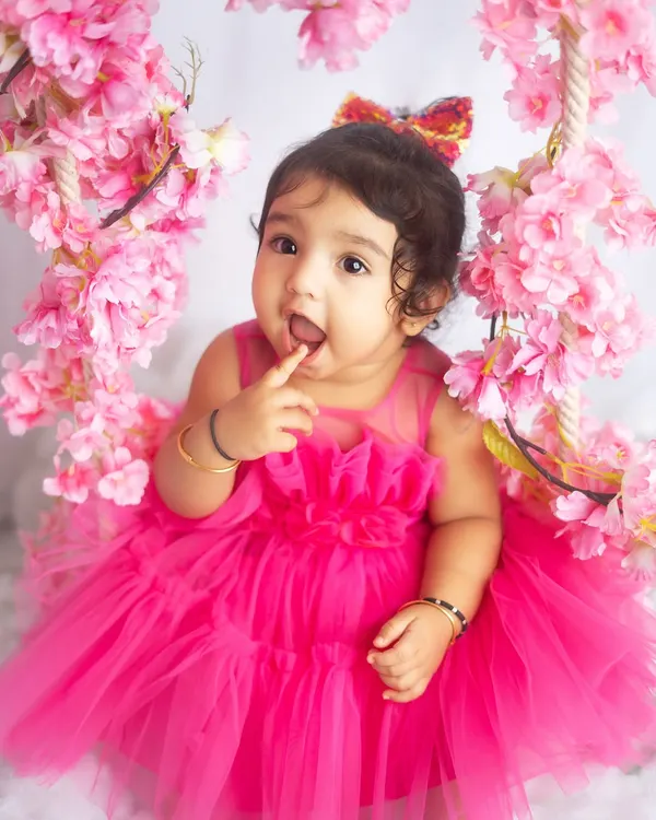 A little princess in pink. This floral swing setup is perfect for creating dreamy, fairytale-like portraits for your baby girl.