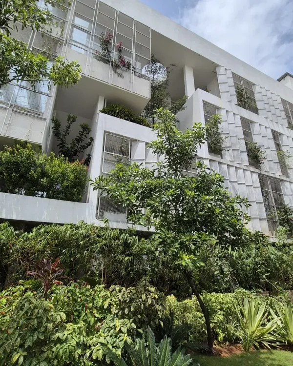 This building demonstrates my core belief that architecture should set the stage for the landscape to perform. Here, the clean lines of the structure provide a framework for lush greenery to flourish, creating a seamless transition between the built and natural worlds.