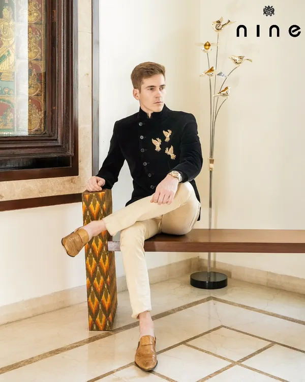 This black velvet Angrakha-style bandhgala is one of my signature pieces. The antique gold embroidered flying birds add a touch of poetic elegance, making it a perfect outfit for a cocktail evening or reception.