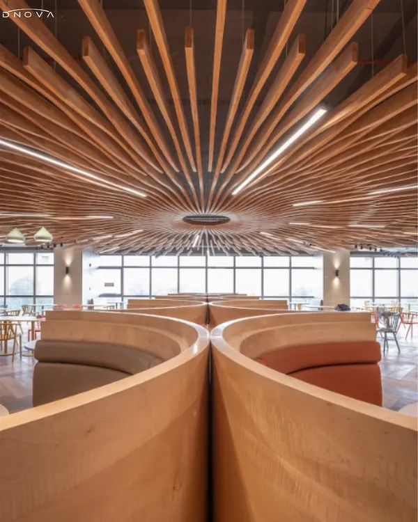 This is the Govo Google Cafe, a space I brought to life through a complete design and build service. The centerpiece is this custom-fabricated wooden baffle ceiling, designed to create a sense of movement and wonder. The curved seating pods offer intimate spaces for conversation within the larger, dynamic cafeteria environment.