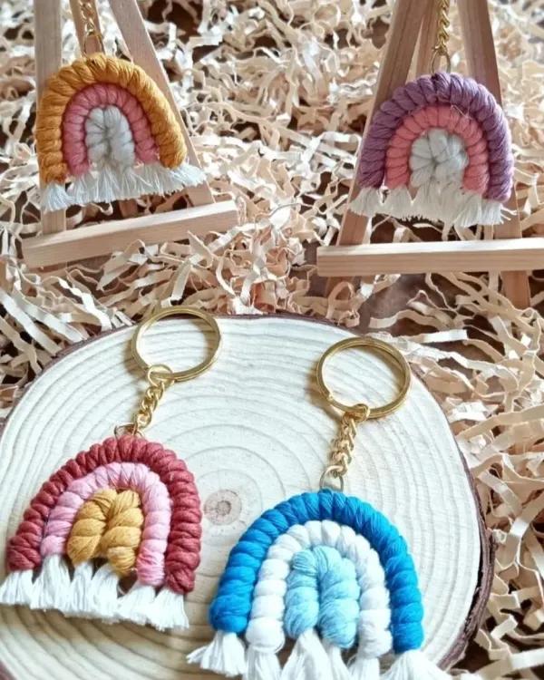 My macrame rainbow keychains are perfect for return gifts and gift hampers. Here they are displayed on mini easels, showing off their vibrant colors and cute, fringed clouds.