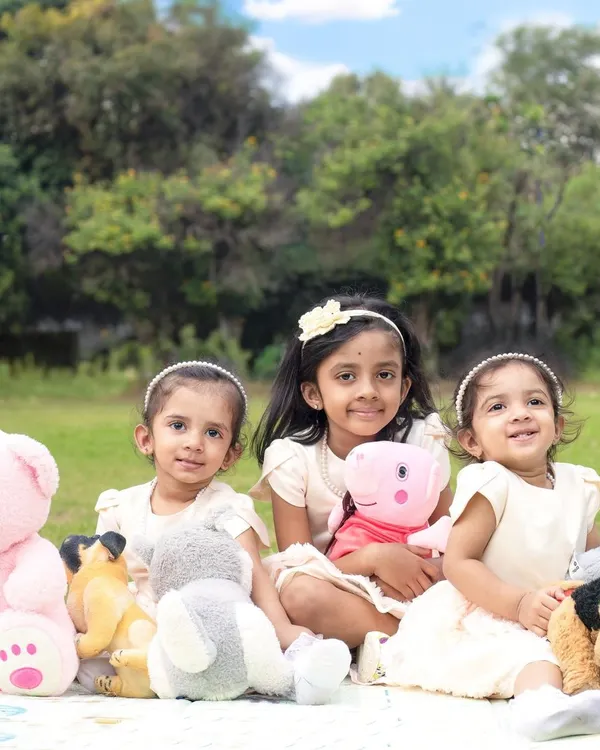 Three times the laughter, three times the love. An outdoor picnic with teddy bears makes for a fun and adorable photoshoot for these sweet sisters.