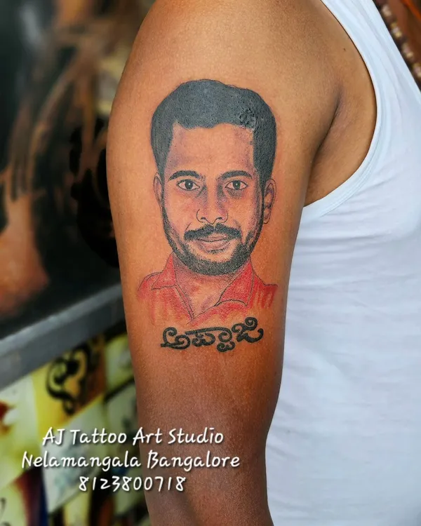This is the kind of work I love to do. A realistic portrait tattoo to honor 'Appaji' (father), capturing his likeness on the upper arm. Creating these memorial tattoos is a privilege.