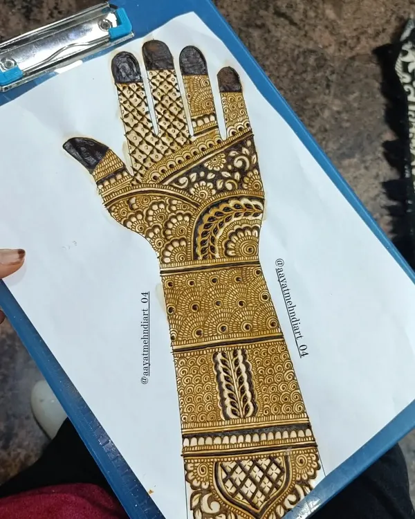 Practice makes perfect. Here is a full Indian mehendi design sketched out on paper, allowing me to refine the patterns before applying them to skin.