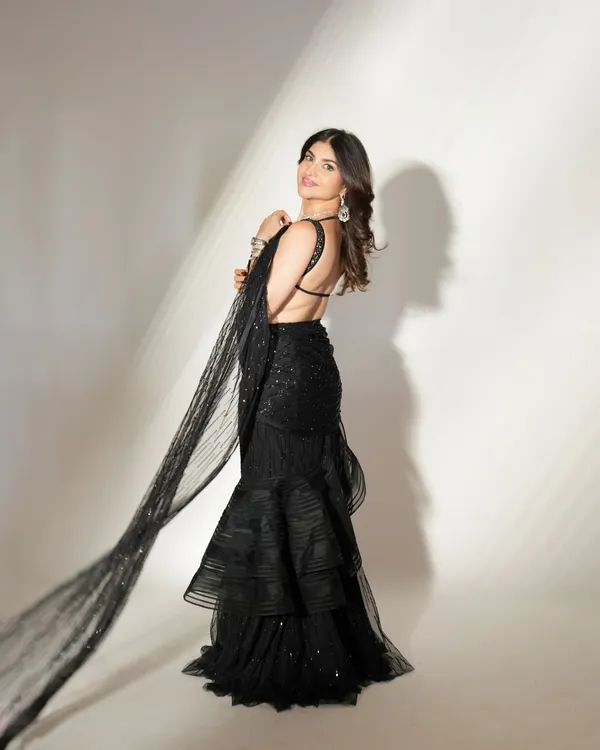 This is the ultimate inspiration for a cocktail night or sangeet glam. A stunning black ruffled saree paired with soft, glowing makeup and a radiant smile creates a look that is both elegant and dramatic.